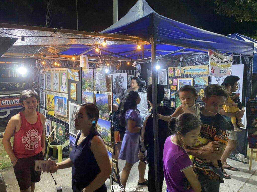 Ringing in a New Era: Guihulngan Kampana Artists Ignite the Local Art Scene with "PintaPasiugda"! 6 a group of people standing in front of a tent